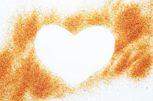 Heart symbol made from sand on white background