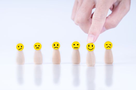 Businessman chooses a happy emoticon icons face.  Service, communication concept