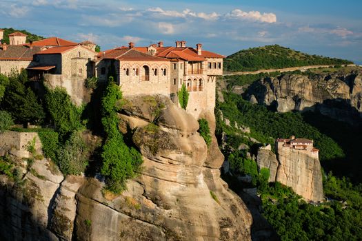 Monastery of Varlaam monastery and Monastery of Rousanou in famous greek tourist destination Meteora in Greece on sunset with scenic scenery landscape