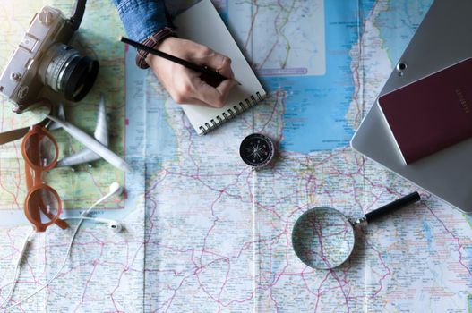 Compass and hand to planning vacation trip and accessories for travel