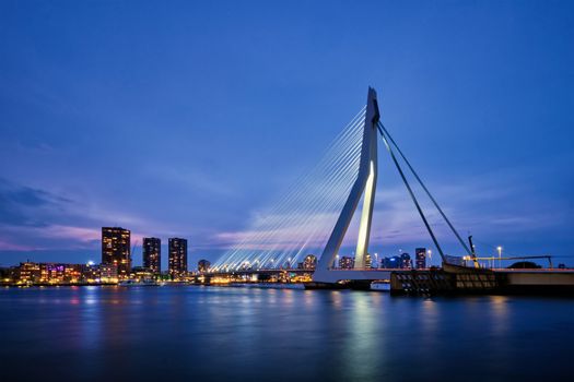 Erasmus Bridge (Erasmusbrug) and Rotterdam skyline illuminated at night. Rotterdam, Netherlands