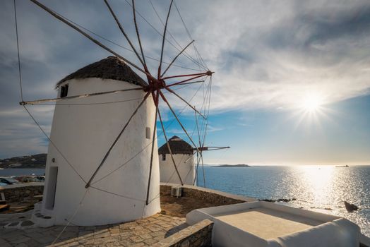 Scenic view of famous Mykonos town windmills. Traditional greek windmills on Mykonos island on sunset, Cyclades, Greece. Walking with steadycam.