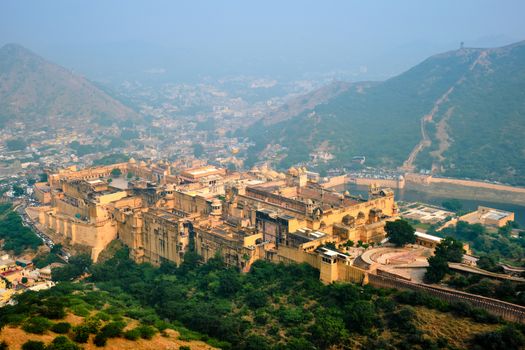 Indian travel famous tourist landmark - view of Amer (Amber) fort and Maota lake from Jaigarh Fort. Jaipur, Rajasthan, India