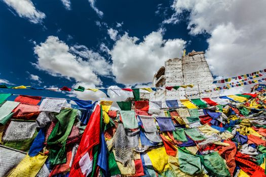 Ruins of Victory Fort Tsemo on the cliff of Namgyal hill and colorful Buddhist prayer flags with Buddhism mantra written on them. Leh, Ladakh, Jammu and Kashmir, India