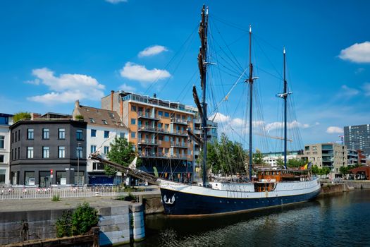 Ship moored in Willemdock in Antwerp. View of Bonapartedok harbor and vintage galleon. Antwerpen, Belgium, Europe, Flanders