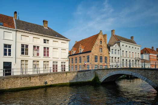 Bruges typical Belgian cityscape Europe tourism concept - canal and old Flemish houses and bridge. Brugge, Belgium