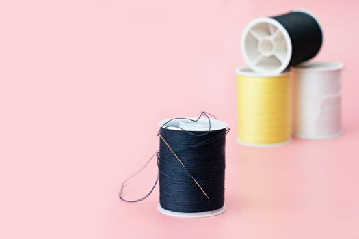 Thread tube with copy space on pink background
