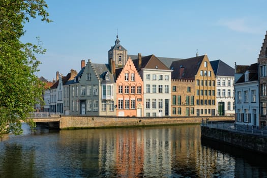 Bruges typical Belgian cityscape Europe tourism concept - canal and old houses and bridge. Brugge, Belgium