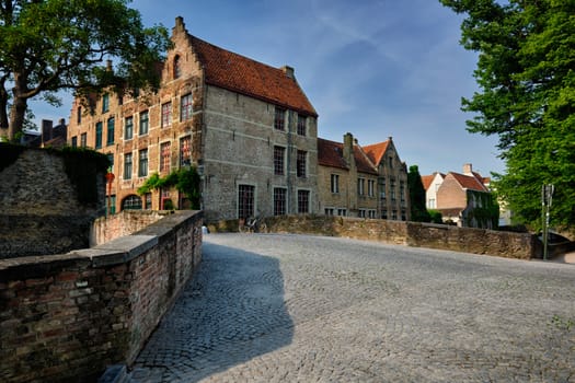 Bruges typical Belgian cityscape Europe tourism concept - canal and old houses and bridge. Brugge, Belgium