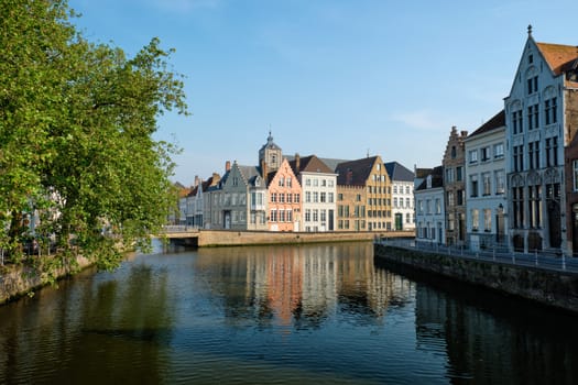 Bruges typical Belgian cityscape Europe tourism concept - canal and old houses and bridge. Brugge, Belgium