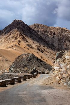 Manali-Leh Highway road from Himachal to Ladakh. Beautiful Indian Himalayan landscape is on the way from Kullu valley to Jammu and Kashmir state. Earthroad highway is more than 400 km. North India