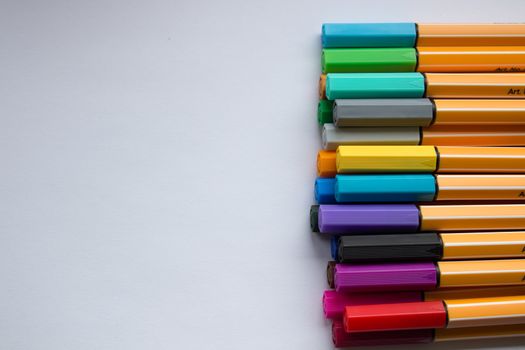 Many different colored pens. Color pencils isolated on a white background.