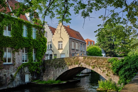 Bruges typical Belgian cityscape Europe tourism concept - canal and old houses and bridge. Brugge, Belgium