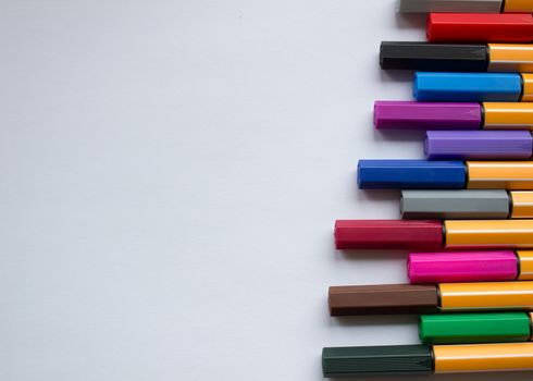 Many different colored pens. Color pencils isolated on a white background.