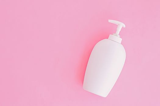 Bottle of antibacterial liquid soap and hand sanitizer on pink background, hygiene product and healthcare, flatlay