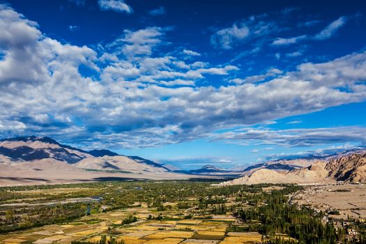 Himalayan landscape of historic Indus valley surrounded by Karakoram range of Himalaya mountains. View from Buddhist temple Thiksey gompa. Ancient civilization of Bronze Age South Asia. Ladakh, India