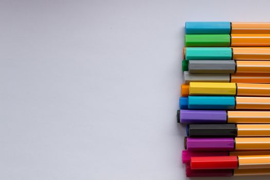 Many different colored pens. Color pencils isolated on a white background.