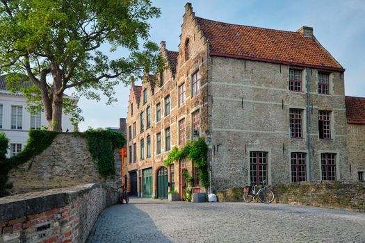 Bruges typical Belgian cityscape Europe tourism concept - canal and old houses and bridge. Brugge, Belgium