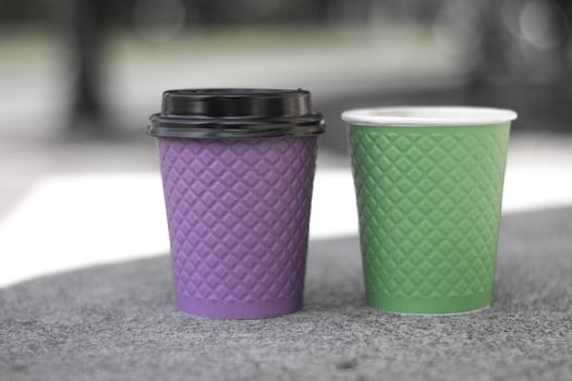 purple and green paper coffee Cup on the stove