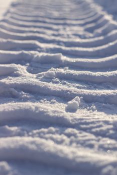 Fresh tracks from the tractor in the snow in winter. Snow clearance