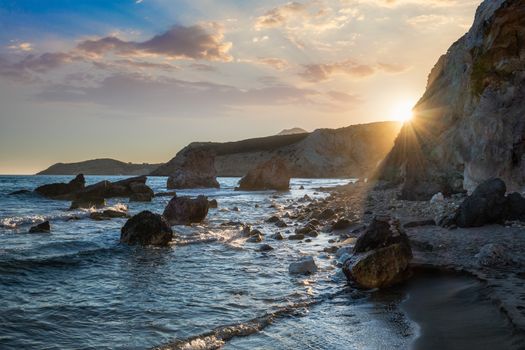 Fyriplaka beach and waves of Aegean sea on sunset, Milos island, Cyclades, Greece