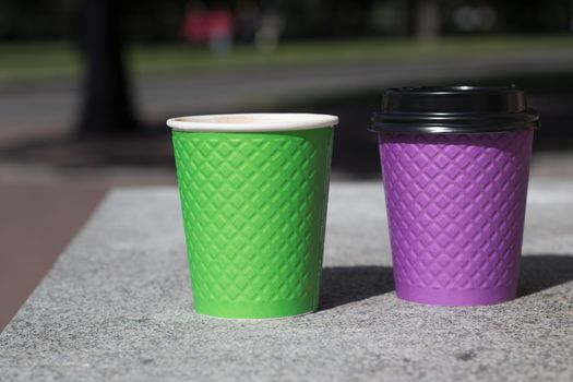 purple and green paper coffee Cup on the stove