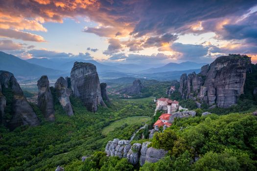 Sunset sky and monastery of Rousanou and Monastery of St. Nicholas Anapavsa in famous greek tourist destination Meteora in Greece with dramatic sky