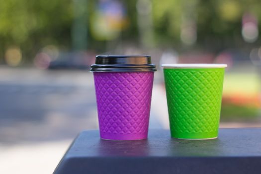 purple and green paper coffee Cup on the stove