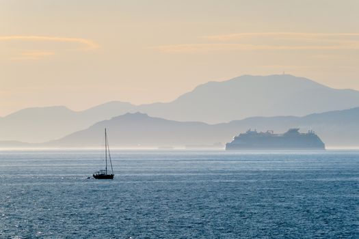 Cruise liner ship and yacht silhouette in Mediterranea sea. Aegean sea, Greece