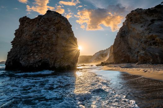 Fyriplaka beach and waves of Aegean sea on sunset, Milos island, Cyclades, Greece