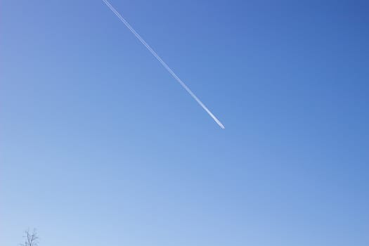 The sky with a strip from the plane, a trace from the plane. Condensation trail.