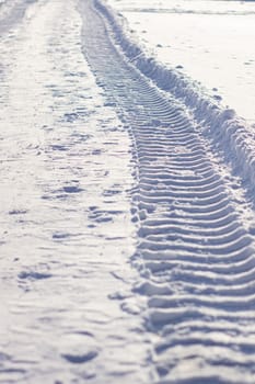 Fresh tracks from the tractor in the snow in winter. Snow clearance