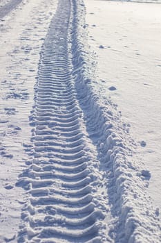 Fresh tracks from the tractor in the snow in winter. Snow clearance