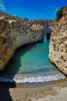 Papafragas hidden beach with crystal clear turquoise water and tunnel rock formations in Milos island, Greece