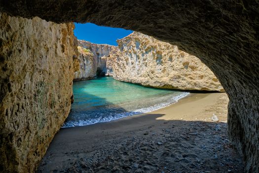 Papafragas hidden beach with crystal clear turquoise water and tunnel rock formations in Milos island, Greece