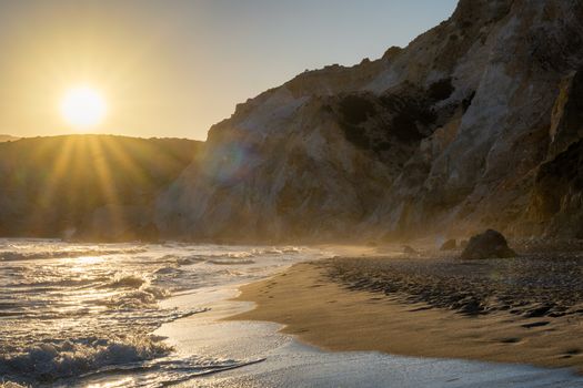 Fyriplaka beach and waves of Aegean sea on sunset, Milos island, Cyclades, Greece