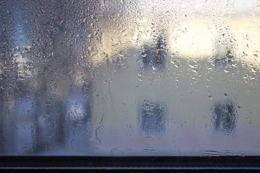 Close-up clear drops of water on window glass surface.