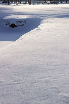 many tracks on the glade covered with snow, paths in the snow, snow-covered meadow.