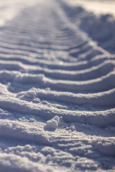 Fresh tracks from the tractor in the snow in winter. Snow clearance