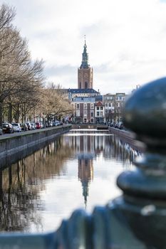 Saint James church reflected on the canal calm water nested to the royal stable, in The Hague 