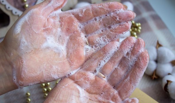 Soapy hands. Lathered women's hands. Detergent.