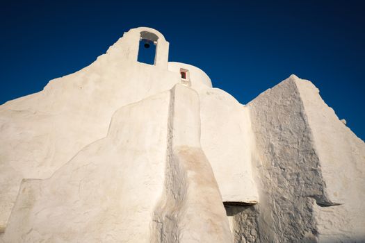 Famous tourist landmark of Greece - Greek Orthodox Church of Panagia Paraportiani in town of Chora on Mykonos island, Greece on sunrise