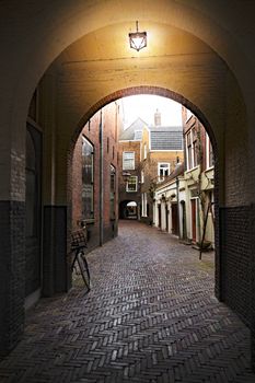 Illuminated dark pathway crossing the Amsterdam residence area, Netherlands