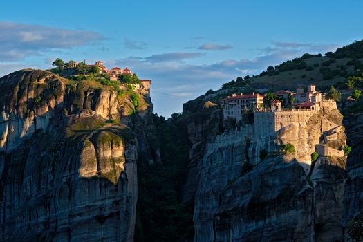 Monastery of Varlaam and Great Meteoron Monastery in famous greek tourist destination Meteora in Greece on sunrise. Horizontal camera pan