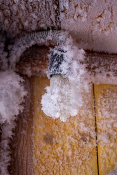 Snow crystals on a wooden wall and a light bulb