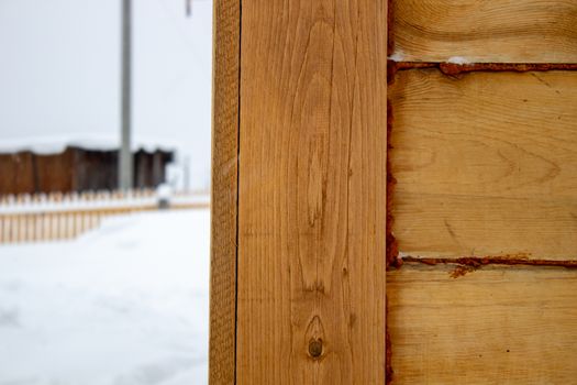 The corner of the wooden house. Close-up. Background. Texture