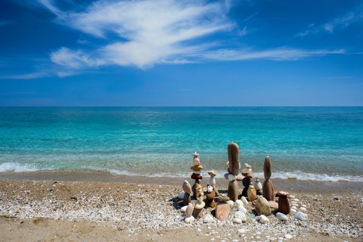 Concept of balance and harmony. Stones pebbles stacks on the beach coast of the blue sea in the nature. Meditative art of stone stacking.