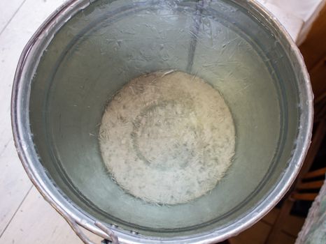 Bucket of water on the table in the cold. Close-up of an ice bucket on the background