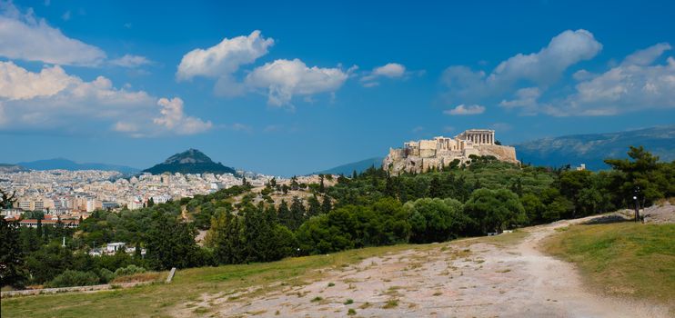 Panorama of famous greek tourist landmark - the iconic Parthenon Temple at the Acropolis of Athens as seen from Philopappos Hill, Athens, Greece