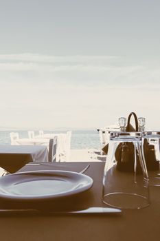 Empty restaurant by the Aegean sea and cruise boat, travel and nature, scene